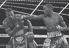  ?? MIKE STOBE, GETTY IMAGES ?? Terence Crawford, right, landing a right to the face of Henry Lundy, is a 6- 1 favorite to beat Viktor Postol on Saturday.