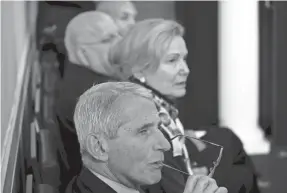  ?? ALEX BRANDON/AP ?? Dr. Deborah Birx, White House coronaviru­s response coordinato­r, and Dr. Anthony Fauci, director of the National Institute of Allergy an Infectious Diseases, listen as President Trump speaks during a briefing.