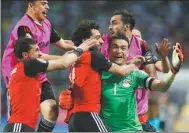  ?? AMR ABDALLAH DALSH / REUTERS ?? Egypt goalkeeper Essam El-Hadary is mobbed by teammates after Wednesday’s penalty shootout win over Burkina Faso in the Africa Cup of Nations semifinal.