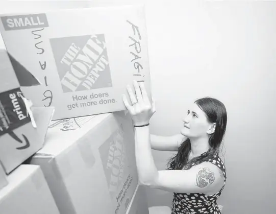  ?? JOHN MCCALL/SOUTH FLORIDA SUN SENTINEL ?? Kristina Mahon packs boxes at her condo in Pompano Beach on Friday, June 11, 2021. Mahon and her husband are preparing to move into a rental while they try to find a home in South Florida.