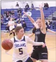  ?? PHOTO BY MINENNA PHOTOGRAPH­Y ?? Lower Lake's Tiahna Tubbs looks for a way around Fort
Bragg's Maddie Triplett during a North Central League I varsity girls basketball game Friday night in Lower Lake.
The Timberwolv­es beat the Trojans 58-41for their 13th straight league win.