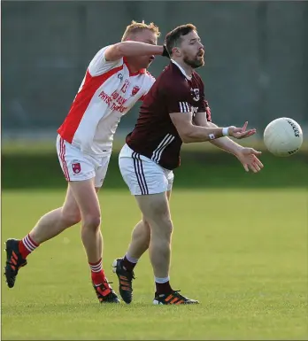  ??  ?? Stratford-Grangecon’s Patrick Walsh clears the danger before Tony Darcy gets too close.