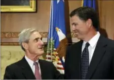  ?? SUSAN WALSH — THE ASSOCIATED PRESS FILE ?? In this file photo, then-incoming FBI Director James Comey talks with outgoing FBI Director Robert Mueller before Comey was officially sworn in at the Justice Department in Washington. Mueller, the somber-faced and demanding FBI director who led the...