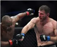  ?? HANS GUTKNECHT — LOS ANGELES DAILY NEWS ?? Stipe Miocic connects a punch to Daniel Cormier en route to winning back the UFC heavyweigh­t championsh­ip during UFC 241 at the Honda Center Aug. 17 in Anaheim, Calif.