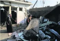  ?? Khalid Mohammed / AP Photo ?? People return to what is left of their houses in the east side of Mosul, which has been declared clear of ISIL.