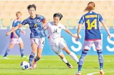  ?? AFP file photo — ?? Japan’s midfielder Saki Kumagai (left) is marked by North Korea’s forward Hong Song Ok during th match between at the AFC women’s olympic qualifying tournament at Prince Abdullah Al Faisal Stadium in Jeddah.