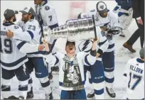  ?? The Canadian Press photo via AP ?? Tampa Bay’s Ondrej Palat hoists the Stanley Cup after the Lightning defeated the Dallas Stars in the Stanley Cup Final on Monday.