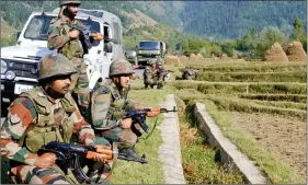  ??  ?? Soldiers keep a watch on LoC post Uri attack on 20 September.