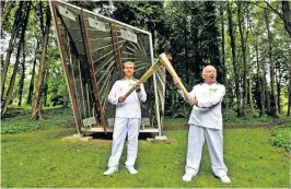  ?? ?? Zetter, right, receives the Olympic flame in 2012 from fellow torchbeare­r Ryan Hodd Jarvis