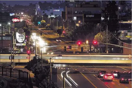  ?? Photograph­s by
Luis Sinco
Los Angeles Times ?? THE EXPO LINE train crosses Crenshaw Boulevard at Exposition Boulevard. Councilman Bernard C. Parks said some of his constituen­ts like the hip sound of SOLA. The area once known as South-Central was renamed South L.A. about 12 years ago.