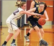  ?? PETE BANNAN — DIGITAL FIRST MEDIA ?? Unionville’s Sarah Covert, right, tries to steal the ball from Oxford’s Miranda Porretta in the first half Tuesday night. Porretta recovered and scored and the Hornets went on to win, 38-32.