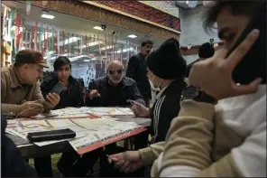  ?? (AP/Vahid Salemi) ?? Voters fill out their ballots during the parliament­ary and Assembly of Experts elections at a polling station in Tehran, Iran, on Friday.