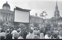  ??  ?? A giant TV screen was erected in Trafalgar Square to allow people to watch the Moon landing and walk in 1969