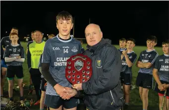  ??  ?? Michael Dwyers captain Eoin Sheridan accepting the under-15 ‘A’ hurling league trophy from Pat Dunne.