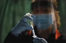  ?? GARY CORONADO/ LOS ANGELES TIMES ?? Ruth Ann Rowan, registered nurse and Tehama County Healthcare coalition coordinato­r, prepares a Moderna COVID-19 vaccinatio­n at a clinic held at the Corning Volunteer Fire Department on Jan. 6.