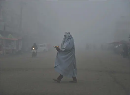  ?? Sanaullah Seiam / AFP ?? DECEMBER 23, 2023 - JANUARY 12, 2024
| Nº. 481
An Afghan woman wears a burqa on a road in Kandahar, about 690 kilometres south-west of the capital, Kabul.
$5.00