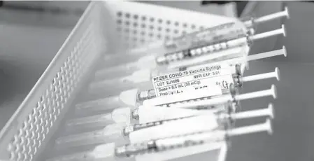  ?? JAE C.HONG/AP ?? President-elect Joe Biden will end holding back the most available COVID-19 vaccines. Above, syringes with the Pfizer-BioNTech vaccine at a hospital in Orange, California.