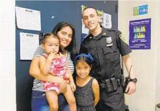  ?? SAM COSTANZA ?? Mom Rebeca Alarcon (with daughter Naomi) holds Leah, who’d stopped breathing when she rushed her to Queens precinct, where Officer Osvaldo Nunez saved her with CPR.