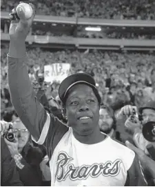  ?? Ap file ?? THE HAMMER: Atlanta Braves’ slugger Hank Aaron holds aloft the ball he hit for his 715th career home run in Atlanta on April 8, 1974. Aaron, who endured racist threats with stoic dignity during his pursuit of Babe Ruth’s mark, died early Friday. He was 86.