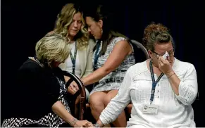  ?? AP ?? Victims of clergy sexual abuse, or their family members, react as Pennsylvan­ia Attorney General Josh Shapiro speaks during a news conference in Harrisburg.