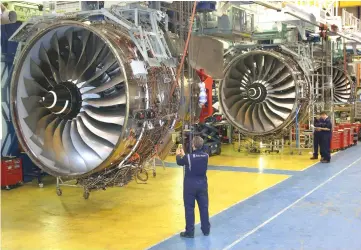  ??  ?? Rolls-Royce’s employees are seen assembling Trent 1000 engines. UMWA had invested RM750 million into the aerospace plant and it has also secured a 25+5 year contract to supply fan cases to RR Trent 1000/Trent 7000 engine final assembly facility in...