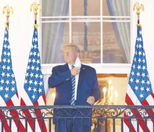  ??  ?? U.S. President Donald Trump removes his mask upon returning to the White House from Walter Reed National Military Medical Center in Washington, D.C., U.S., Oct. 5, 2020.