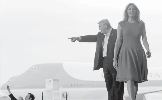  ??  ?? U.S. President Donald Trump and First Lady Melania Trump arrive for a campaign-style rally at Orlando-Melbourne Internatio­nal Airport in Melbourne, Florida, on Saturday.