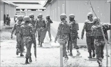  ?? Associated Press ?? KENYA DEFENSE FORCES soldiers patrol Garissa University College, where attackers from Al Qaedalinke­d Shabab killed 148 last week. The extremist group appears to be recruiting young, privileged Kenyans.