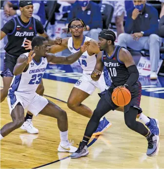  ?? JOHN PETERSON/AP ?? DePaul guard Ray Salnave dribbles against Creighton forward Damien Jefferson during the first half of a game last month in Omaha, Neb. The Blue Demons lost 77-53.
