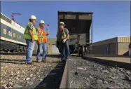  ?? SUSAN MONTOYA BRYAN—ASSSOCIATE­D PRESS ?? This Aug. 20, 2019, image shows workers talking about the impending closure of the Navajo Generating Station near Page, Ariz The power plant will close before the year ends, upending the lives of hundreds of mostly Native American workers who mined coal, loaded it and played a part in producing electricit­y that powered the American Southwest.