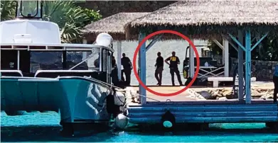  ??  ?? Caught on camera: FBI agents disembark on a jetty at Little St James yesterday