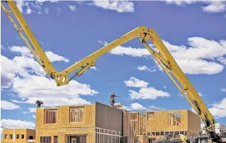  ?? GABRIELA CAMPOS/NEW MEXICAN FILE PHOTO ?? Constructi­on crews work on a new home earlier this year in the Villas de Las Soleras neighborho­od off Governor Miles Road. Santa Fe County’s population grew by more than 10,000 during the last decade.