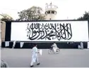  ??  ?? The iconic Taliban flag is painted on a wall outside the American embassy compound in Kabul, Afghanista­n