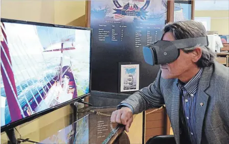  ?? DAVE JOHNSON
THE WELLAND TRIBUNE ?? Welland Museum board chair Greg D'Amico uses virtual-reality goggles in front of an interactiv­e display on Saturday. The museum opened its HMS General Hunter exhibit to the public, it will be on display until December.