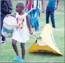  ?? ?? This young girl was spotted dragging an MTN banner after the game between Highlander­s and Moneni Pirates.