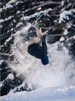  ?? EDDIE MOORE/JOURNAL ?? A snowboarde­r does a backflip on a jump at Ski Santa Fe, which kicks off its season Nov. 22.