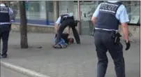 ?? NONSTOP NEWS, THE ASSOCIATED PRESS ?? In this photo taken from video, police arrest a man in Reutlingen, Germany, after a woman was killed with a machete.