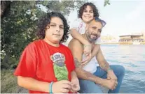  ?? JOHNMCCALL/SOUTHFLORI­DASUNSENTI­NEL ?? Isziah Zuniga, left, stands next to his dad, Luis, and brother Iszac. Luiswas evicted inOctober.