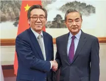  ?? Yonhap ?? Foreign Minister Cho Tae-yul (left) and his Chinese counterpar­t Wang Yi shake hands during a meeting at the Diaoyutai State Guesthouse in Beijing, on Monday.