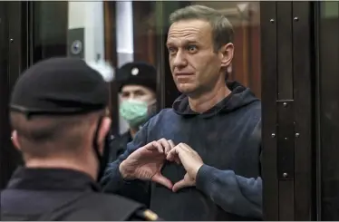  ?? MOSCOW CITY COURT VIA THE ASSOCIATED PRESS, FILE ?? In this file photo made from video provided by the Moscow City Court on Feb. 3, 2021, Russian opposition leader Alexei Navalny makes a heart gesture standing in a cage during a hearing in the Moscow City Court in Moscow, Russia.