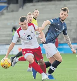  ?? Picture: George McLuskie. ?? East Fife’s Aaron Dunsmore slips away from Kieran MacDonald of Raith Rovers.