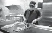  ?? JOHN MCCALL/
SUN SENTINEL ?? Food is prepared on a hibachi grill at Chow Time Grill & Buffet in Tamarac on April 13. Chow Time is a part of Tamarac’s restaurant scavenger hunt through Sept. 30.