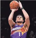  ?? MARY ALTAFFER/AP ?? Suns guard Devin Booker shoots a 3-pointer during the second half of a Feb. 7 game against the Brooklyn Nets. The Suns won 116-112.