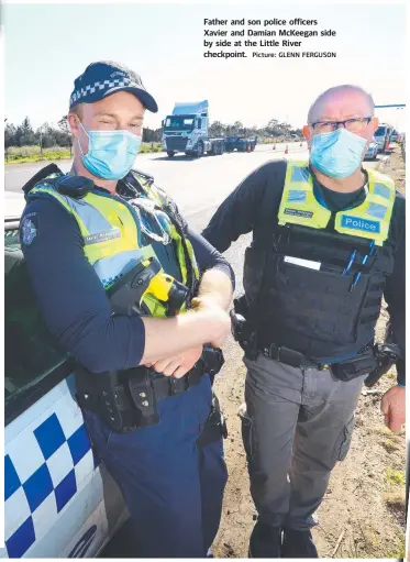  ?? Picture: GLENN FERGUSON ?? Father and son police officers Xavier and Damian McKeegan side by side at the Little River checkpoint.