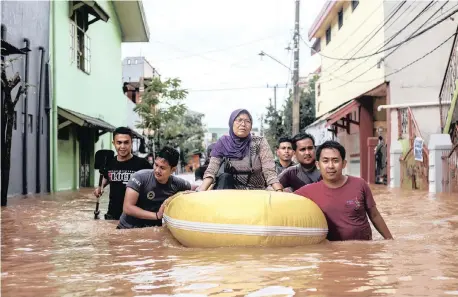  ?? AP African News Agency (ANA) ?? A WOMAN is rescued by means of a rubber boat during floods in Makassar, Indonesia. |