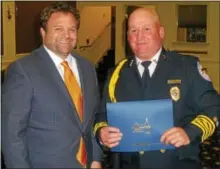  ?? FRAN MAYE — 21ST CENTURY MEDIA ?? Steve “Monk” Melton accepts a Distinguis­hed Service Award from Kennett Square Mayor Matt Fetick Monday night. Melton served as Kennett No. 1 fire chief for the past 12 years.