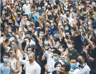  ?? AFP PHOTO ?? Pro- democracy demonstrat­ors hold up their hands to symbolize their five demands during a protest against an expected government ban on protesters wearing face masks in Hong Kong. The island-state’s government was expected to enact such law, a move opponents said would be a turning point that tips the financial hub into authoritar­ianism.