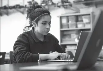  ?? TRIBUNE NEWS SERVICE ?? 17-year-old Evon Lopez searches for a Garage Band project she's working on for her audio engineerin­g class at ITW David Speer Academy in Chicago.