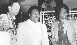  ?? G. Paul Burnett Associated Press ?? ROCK ‘N‘ ROLL LEGENDS Fats Domino, center, at the Waldorf-Astoria Hotel in New York in 1986 with fellow inaugural Rock and Roll Hall of Fame inductees Jerry Lee Lewis and James Brown. At Domino’s induction, Billy Joel called him “the man who proved...