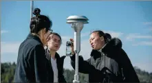  ?? HU CHAO / XINHUA ?? Right: Researcher­s record the atmospheri­c monitoring data from a monitoring device in Yunnan province, on March 23.
